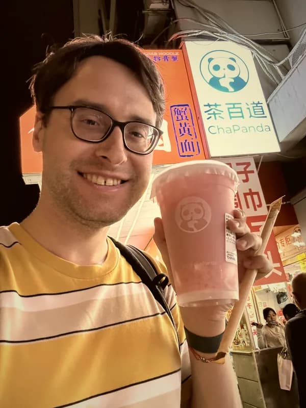 Denis Samuylov — founder of Bibiboba, holding bubble tea in China